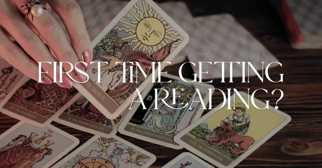 woman's hand holding The Sun Tarot card with text "first time getting a tarot card reading"