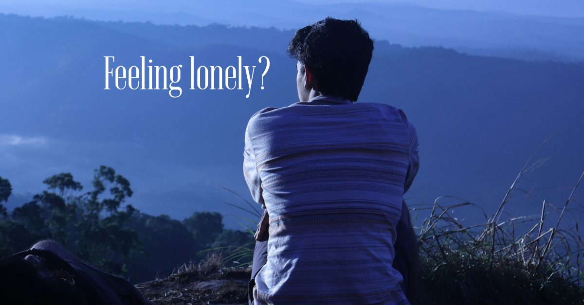 man sitting and looking on blue mountain background with text "feeling Lonely?"