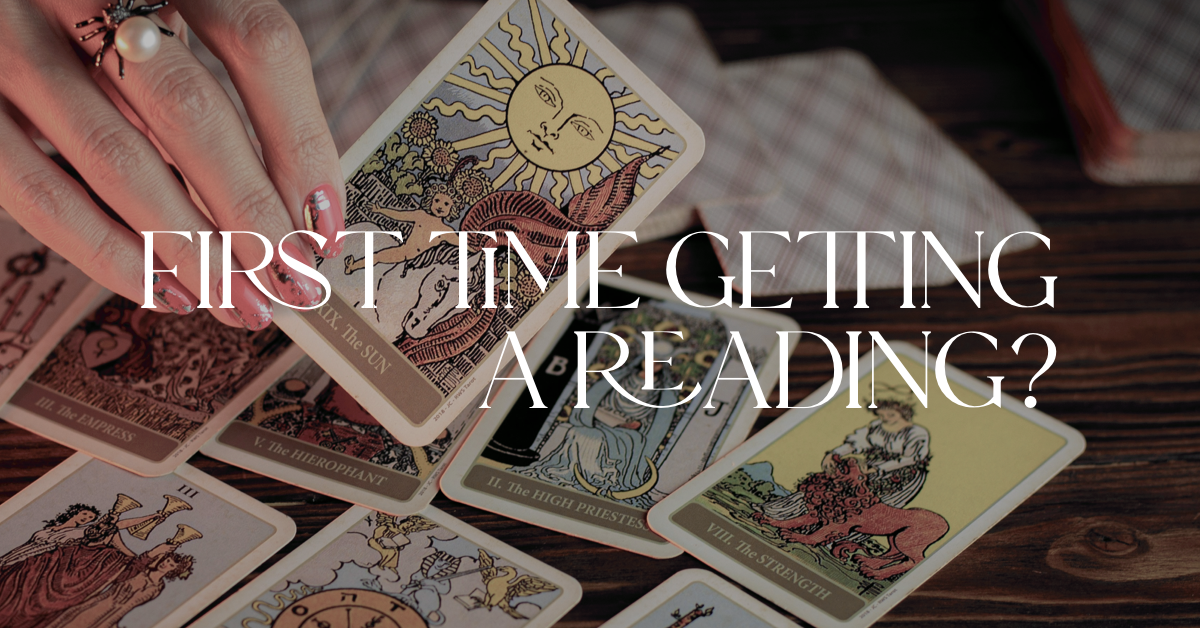 woman's hand holding The Sun Tarot card with text "first time getting a tarot card reading"