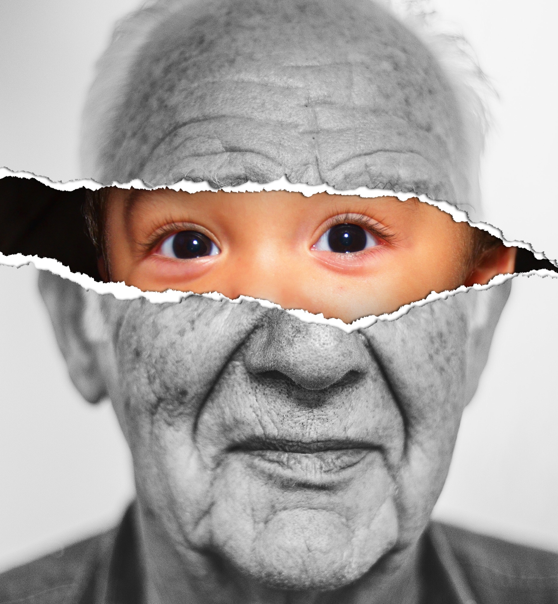 Black and white picture of an old man's face with a tear across the eyes under the tear there is a baby face
