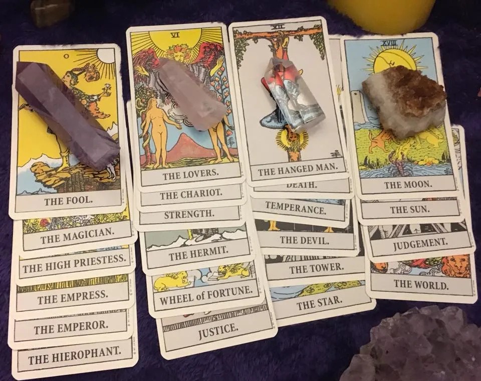 Major Arcana Tarot cards from a Rider-Waite deck with crystals placed on top