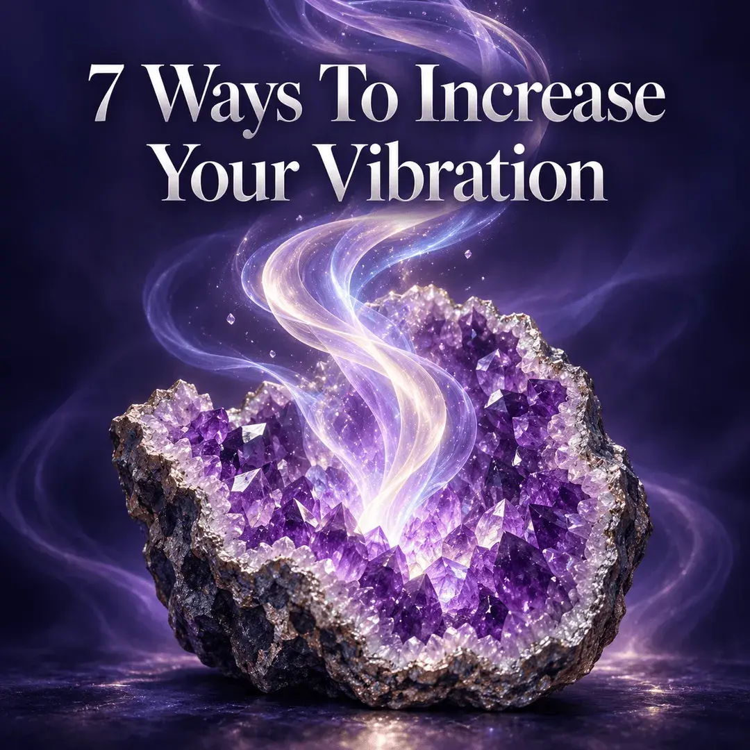 An amethyst geode glowing with rising ribbons of violet and gold light, representing ways to raise your vibration