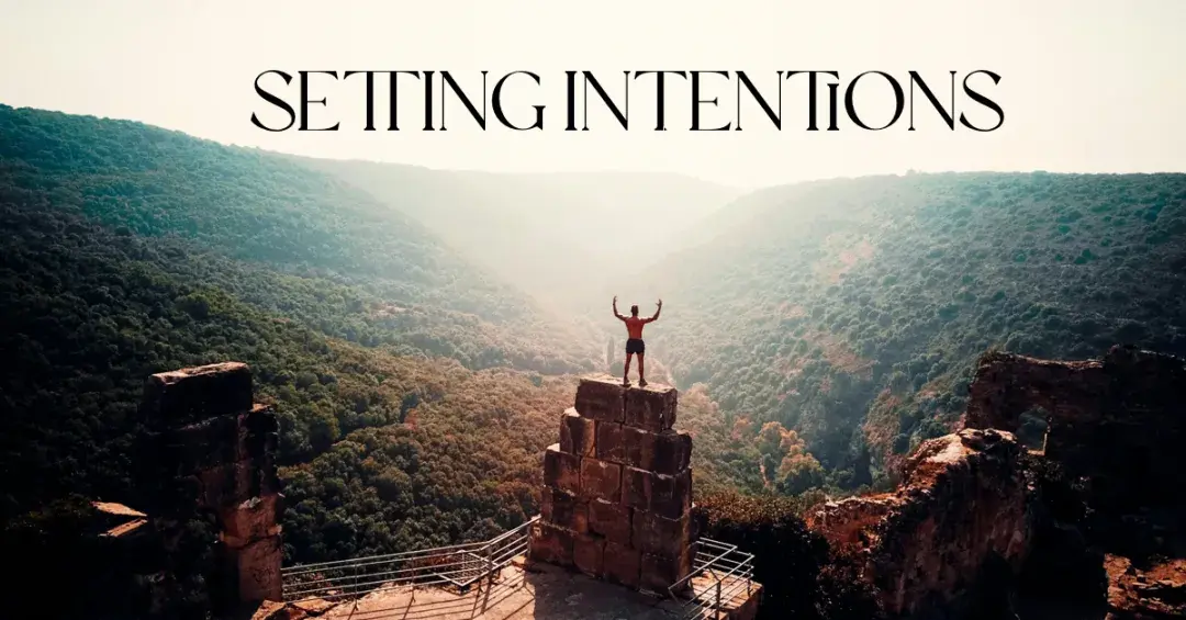 man on top of mountains with text "setting intentions"