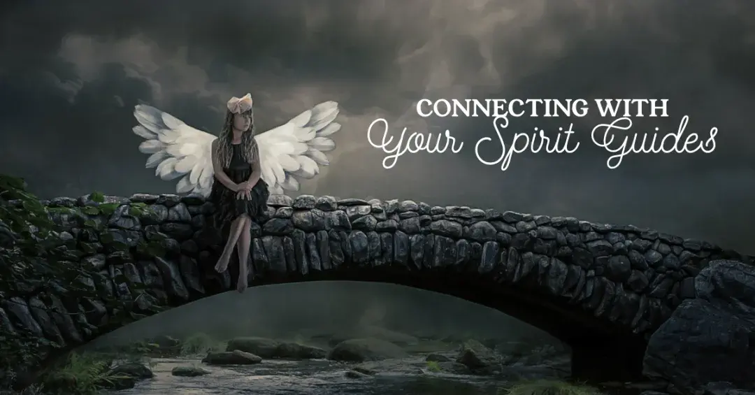 woman with angel wings sitting on arched stone bridge with a dark sky background with text "connecting with your spirit guides"