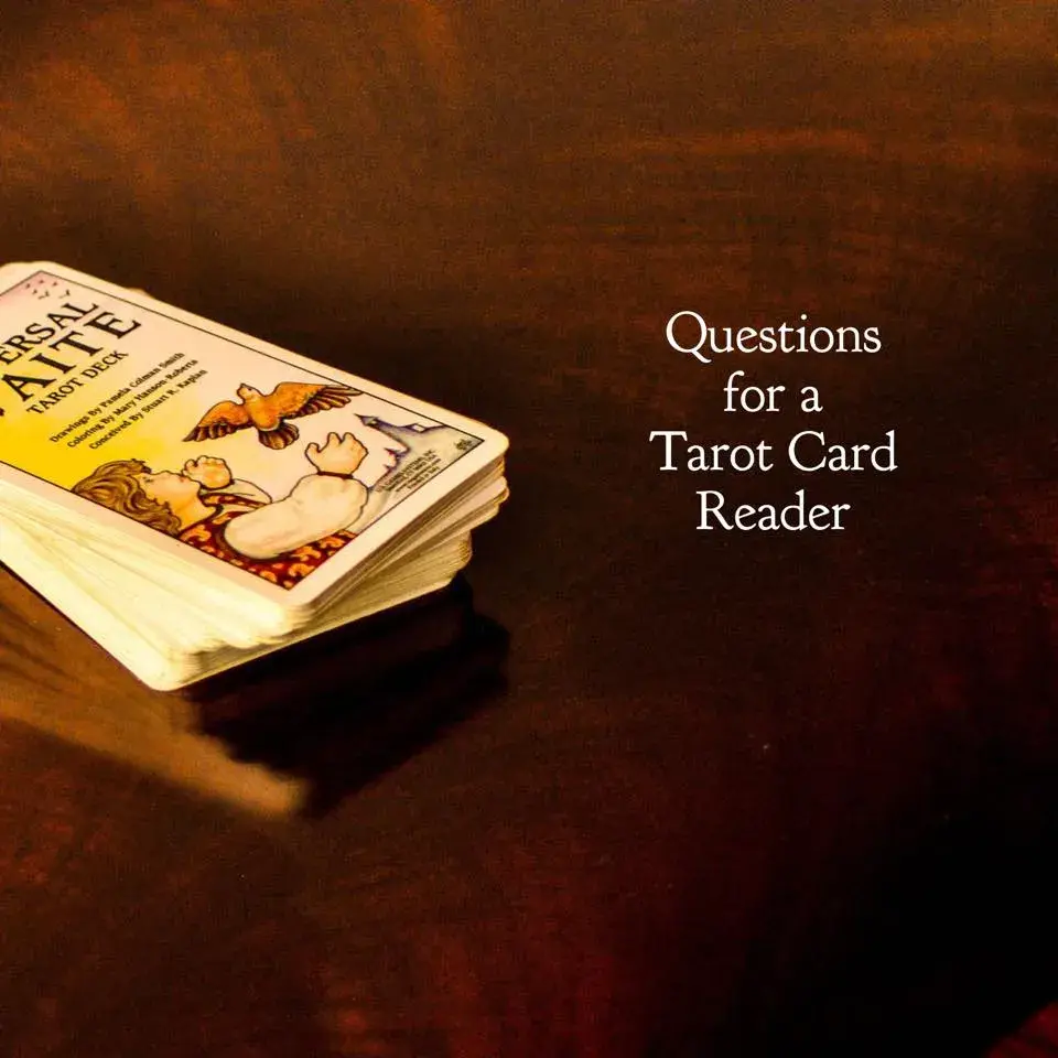 Tarot cards on a brown background with text "questions for a Tarot Card Reader"