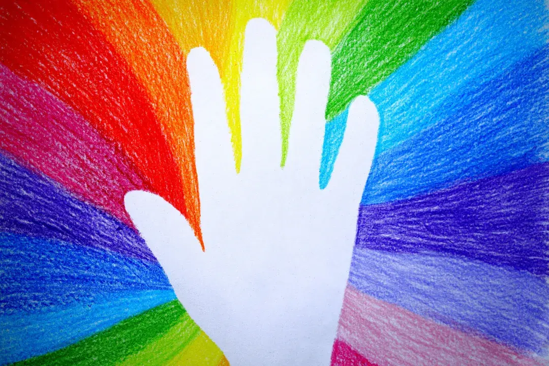Rainbow aura colors and energy field surrounding a hand