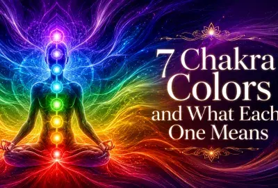 Meditating figure with seven glowing chakra colors from red to violet.