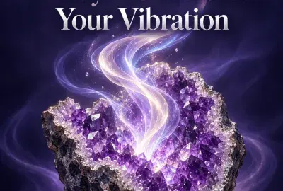 An amethyst geode glowing with rising ribbons of violet and gold light, representing ways to raise your vibration