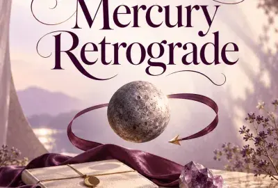 The planet Mercury circled by a plum ribbon above a journal and amethyst on a sunlit marble ledge