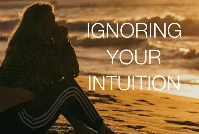 woman looking out into ocean with text "Ignoring your intuition"