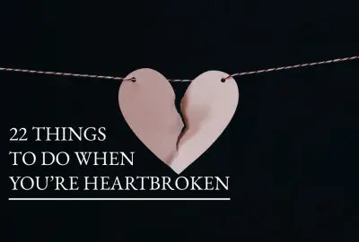 Paper heart split down middle with text "22 things to do when you're heartbroken"