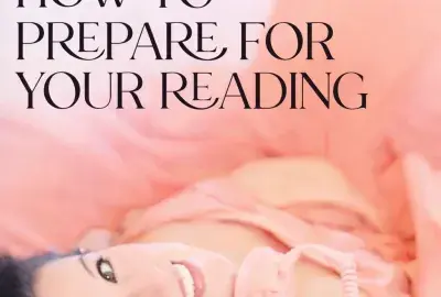 Woman smiling while holding a phone, representing how to prepare for a phone psychic reading and what to expect during a session
