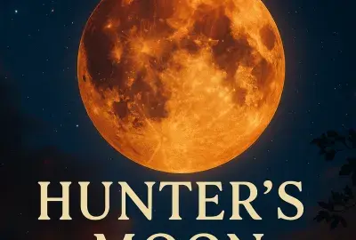 Amber-orange Hunter’s Moon glowing in the autumn night sky, symbolizing focus, intuition, spiritual preparation, and seasonal transformation.