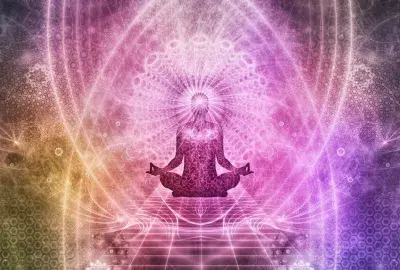 meditating human form in lotus position with energy all around