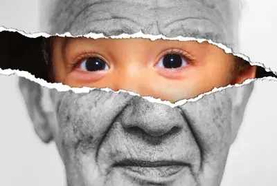 Black and white picture of an old man's face with a tear across the eyes under the tear there is a baby face