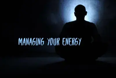 white light aimed at darkness with a human head looking out