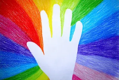 hand with rainbow colored around