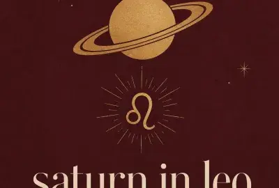 Gold Saturn and Leo symbols on a burgundy background with the words Saturn in Leo.